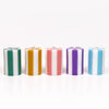 Five striped candles in different colors arranged in a row on a white background
