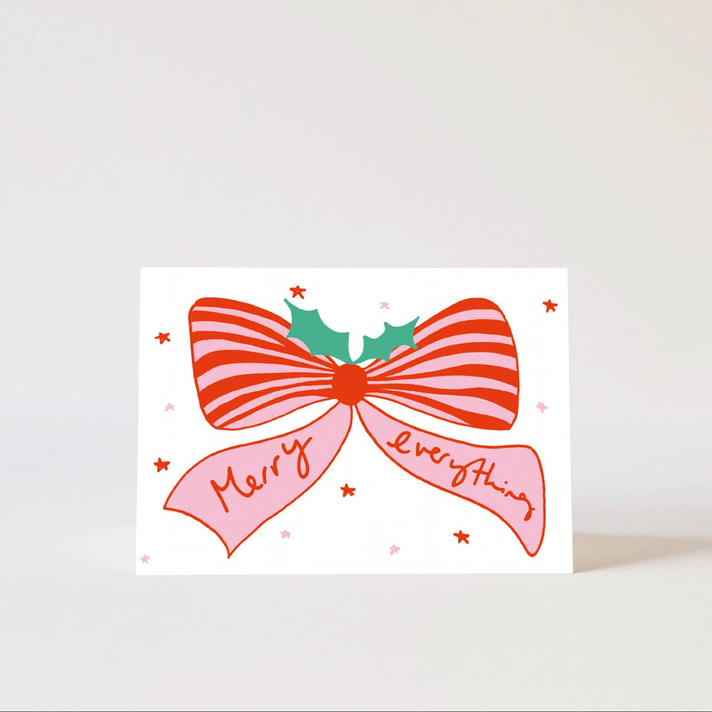 Greeting card with a red bow and 'Merry Everything' text on a white background