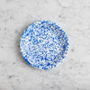 Speckled blue and white circular pattern on a white background