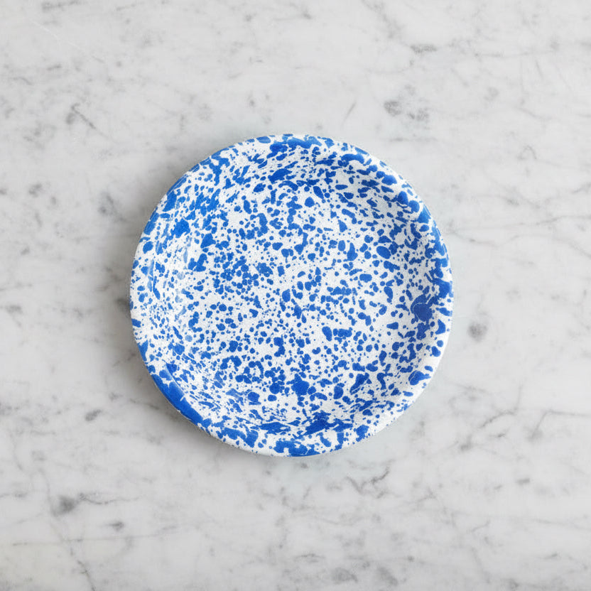 Speckled blue and white circular pattern on a white background
