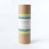 Cardboard tube with patterned label on a white background