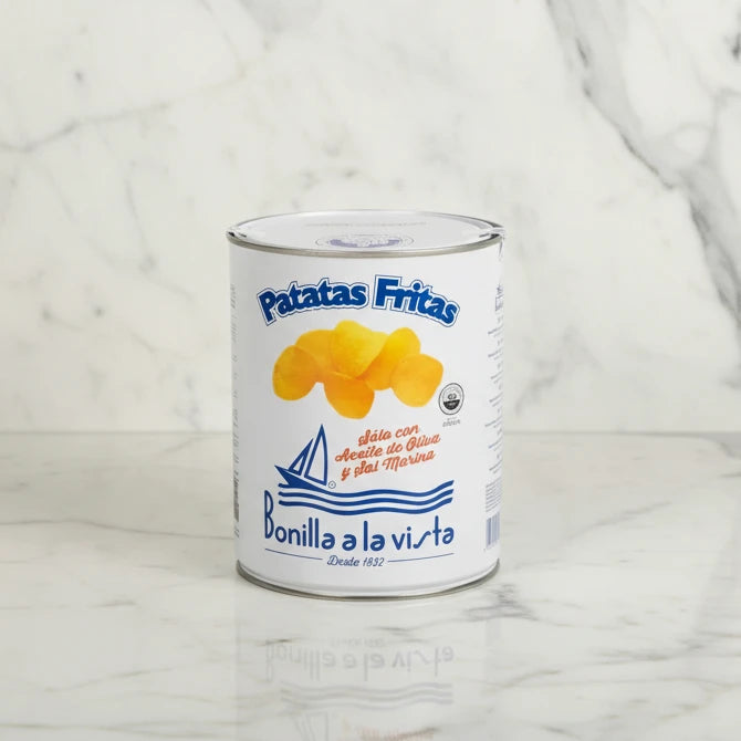 Can of Patatas Fritas with a white label on a light gray background