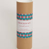 Cardboard tube with a patterned label on a white background