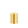 Striped yellow and white candle on a white background