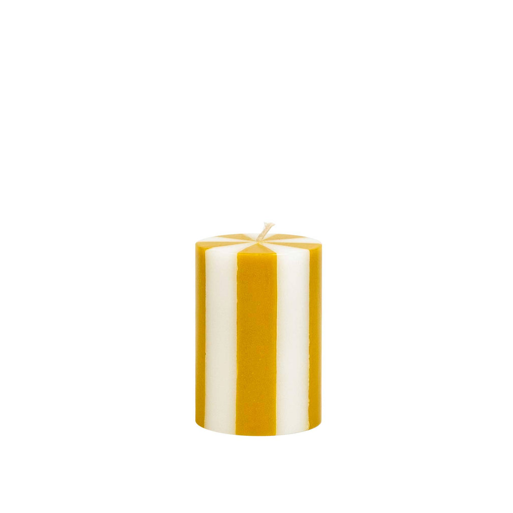 Striped yellow and white candle on a white background