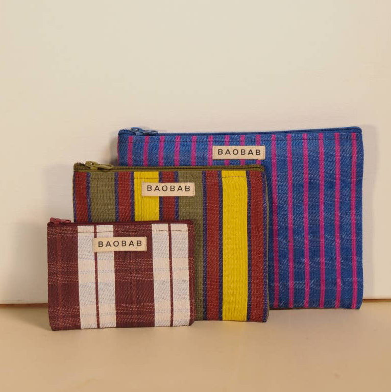 Three striped pouches with 'BAOBA' branding on a beige background