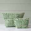 Two fabric pouches with a green hand-drawn dot pattern on a white background, photographed against a clean white studio backdrop.