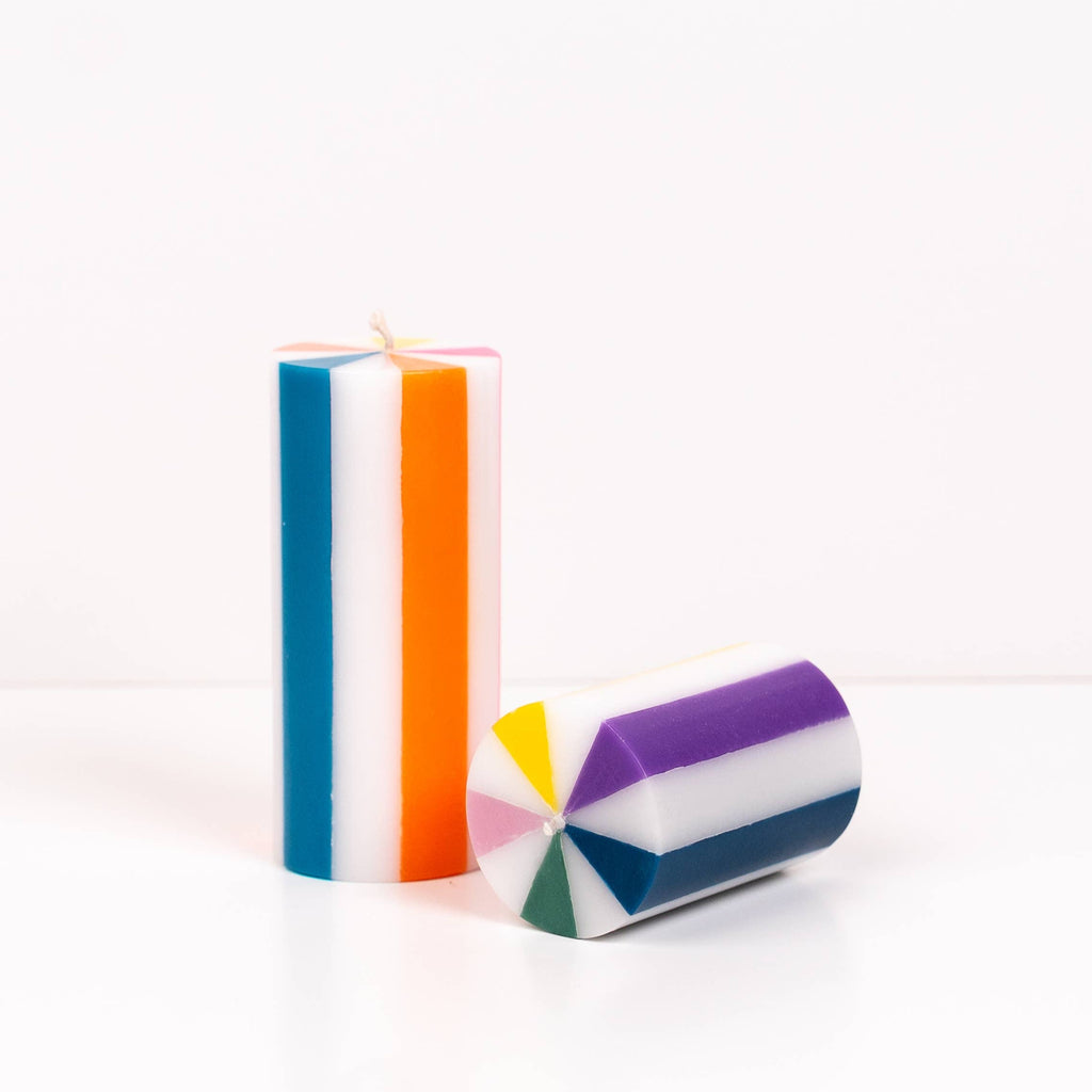 Colorful striped candles on a white background