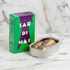 Canned sardines with a green and purple box on a white background