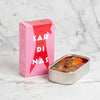 Sardine can and pink box with 'Sardinas' branding on a white background