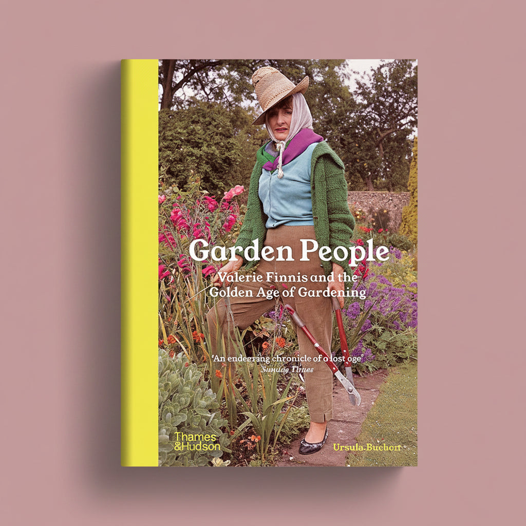 A book cover titled 'Garden People: Valerie Finnis and the Golden Age of Gardening' shown against a muted mauve background. The cover features a woman in a garden wearing a straw hat, green cardigan, lavender scarf, light blue top, and brown trousers, with a bright yellow vertical band on the left side.