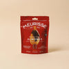Red package of Meurisse almonds on a beige background