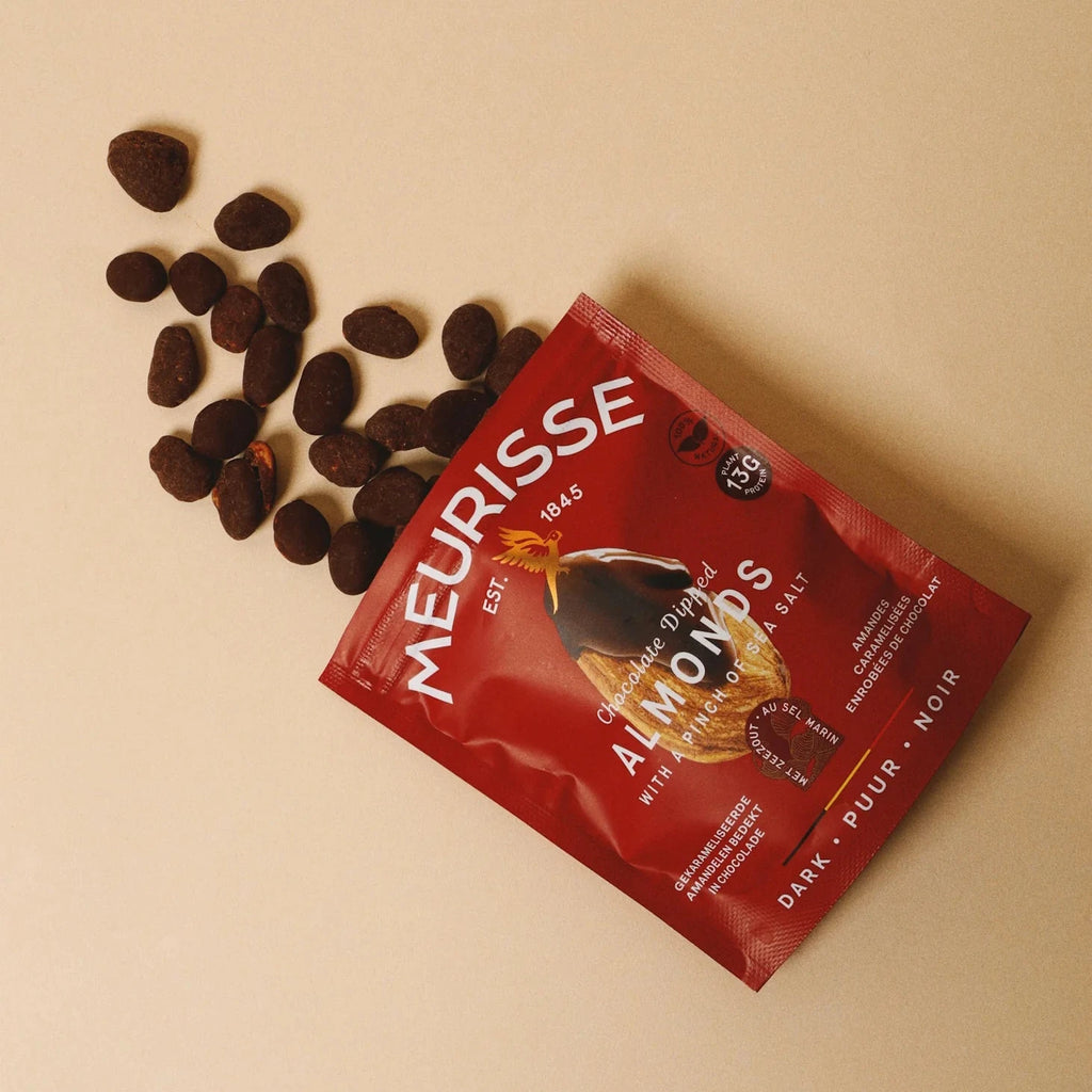 Red Meurisse almond product packaging with almonds on a beige background