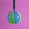 Multicolored ball with a string on a pink background