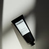 Black tube of Verden skincare product on a light background