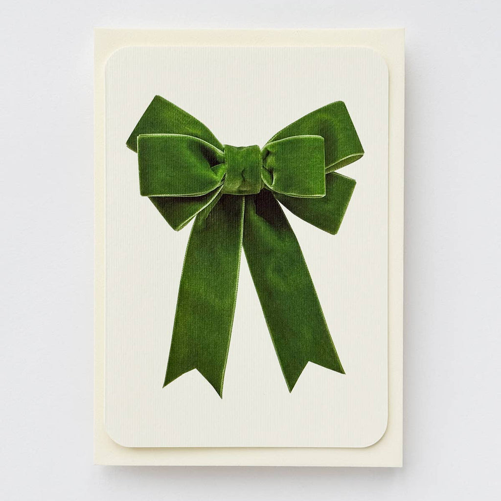 Card with a green velvet bow on a white background