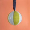 Two-toned ball with a blue string on an orange background