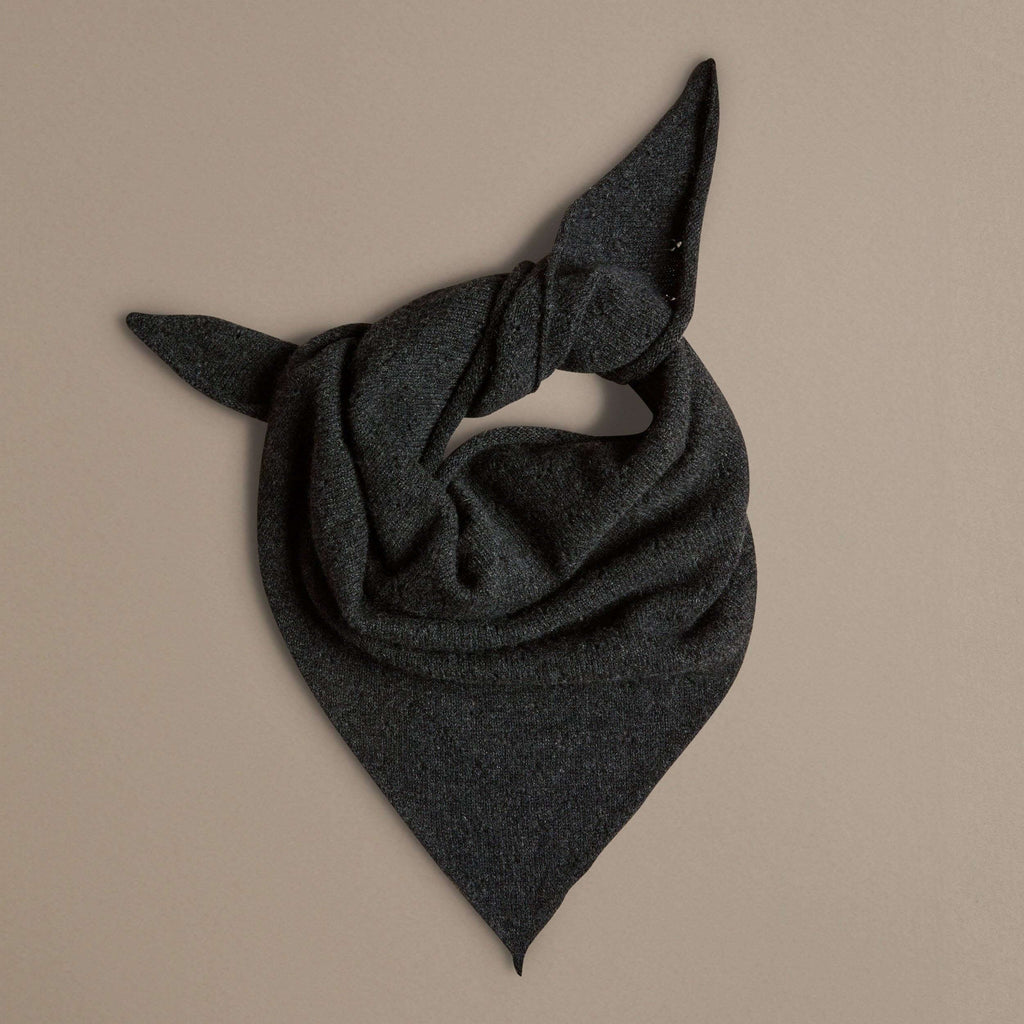 Dark gray triangular scarf on a beige background