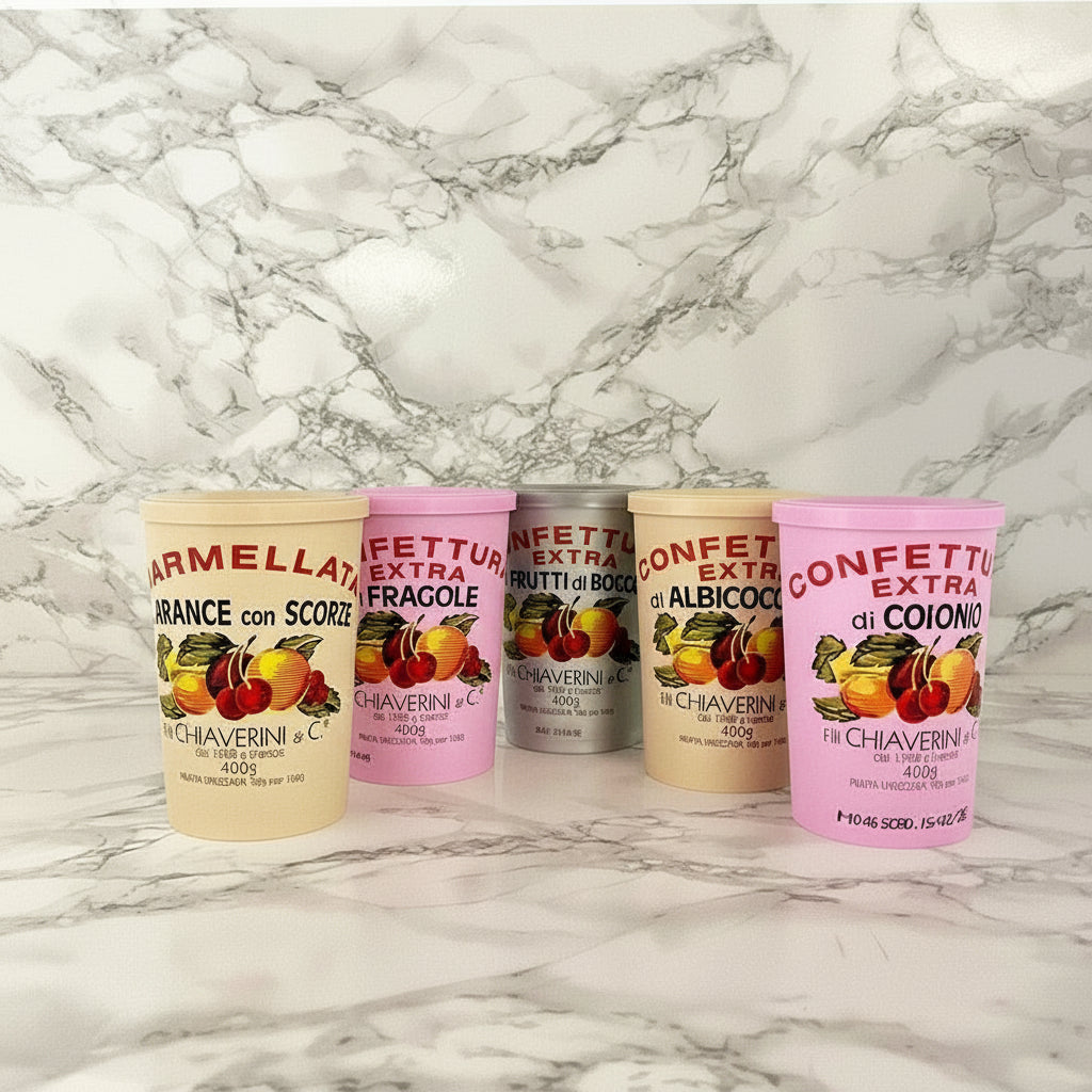 A selection of Chiaverini Firenze jams displayed on a marble surface, with various labels indicating different flavors.