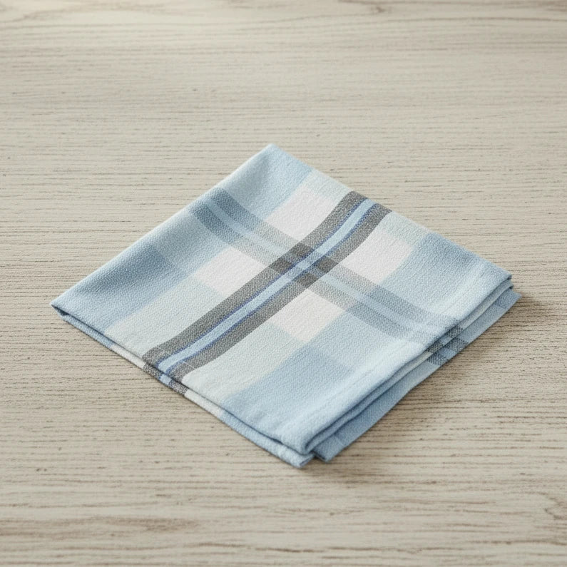 Folded checkered fabric napkin with blue, white, and gray plaid pattern on a white background
