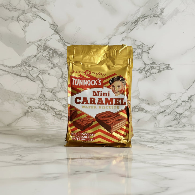 A pack of Tunnock's Mini Caramel Wafers on a marble background.